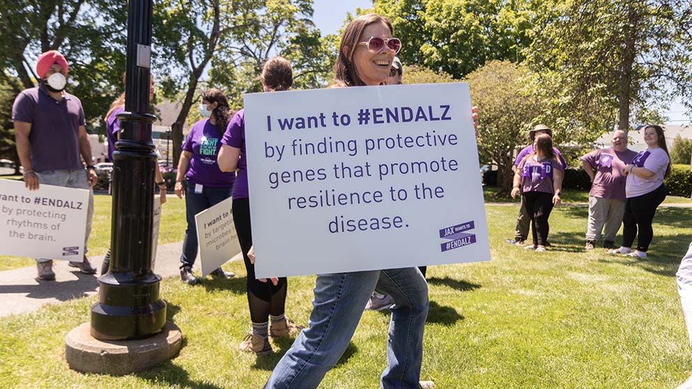 JAX's Catherine Kaczorowski holding an "ENDALZ" sign.