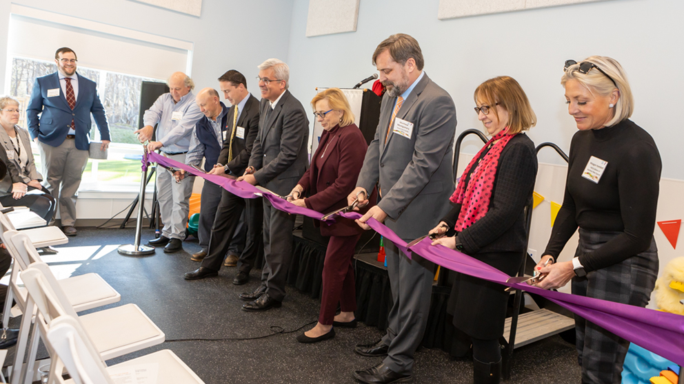 A photo of JAX and YMCA representatives cutting the ribbon on the new JAX and Down East Family YMCA child care center in 2024